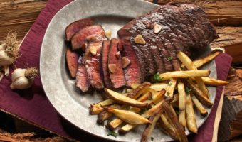 photo of steak and french fries on gray plate