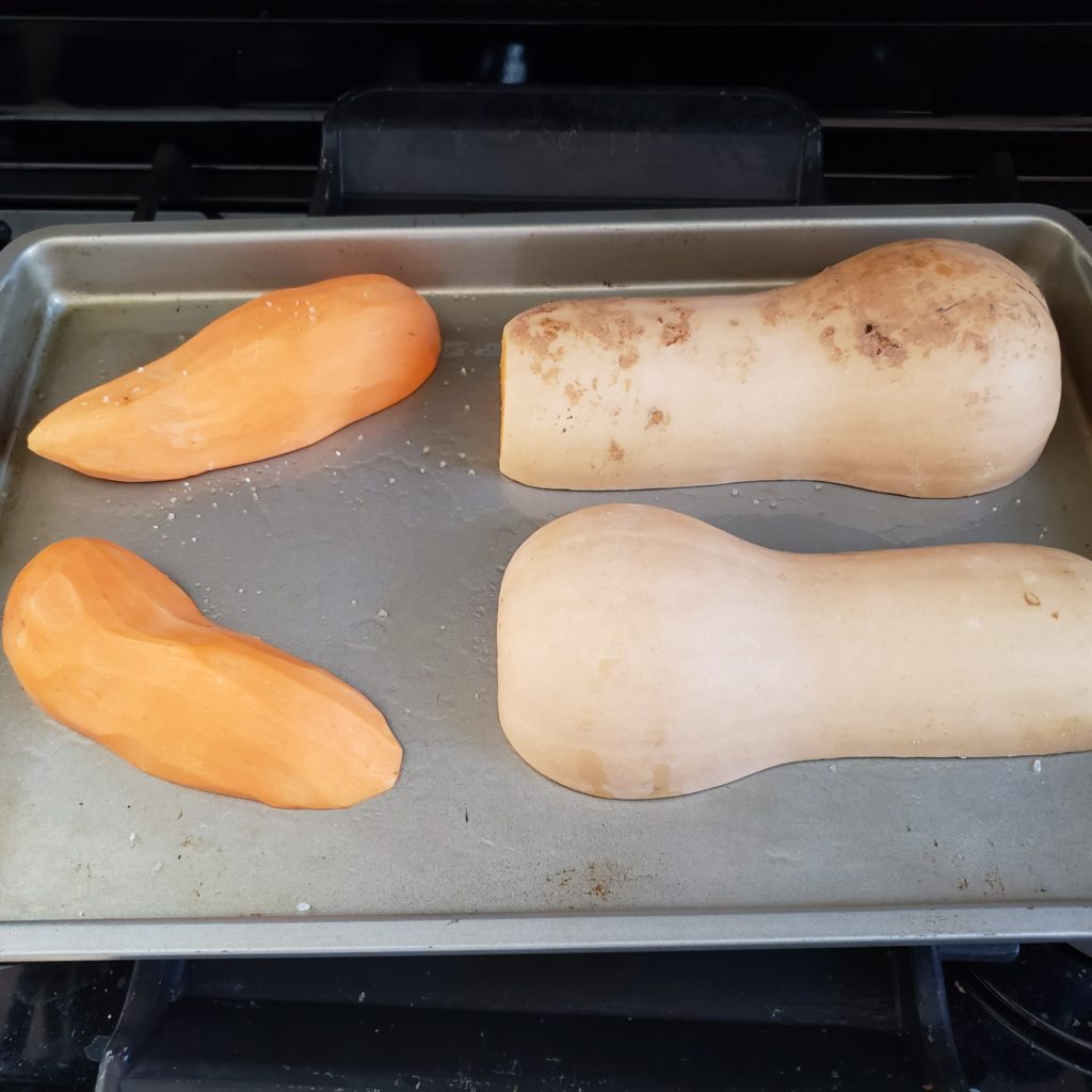Uncooked squash and sweet potato on pan