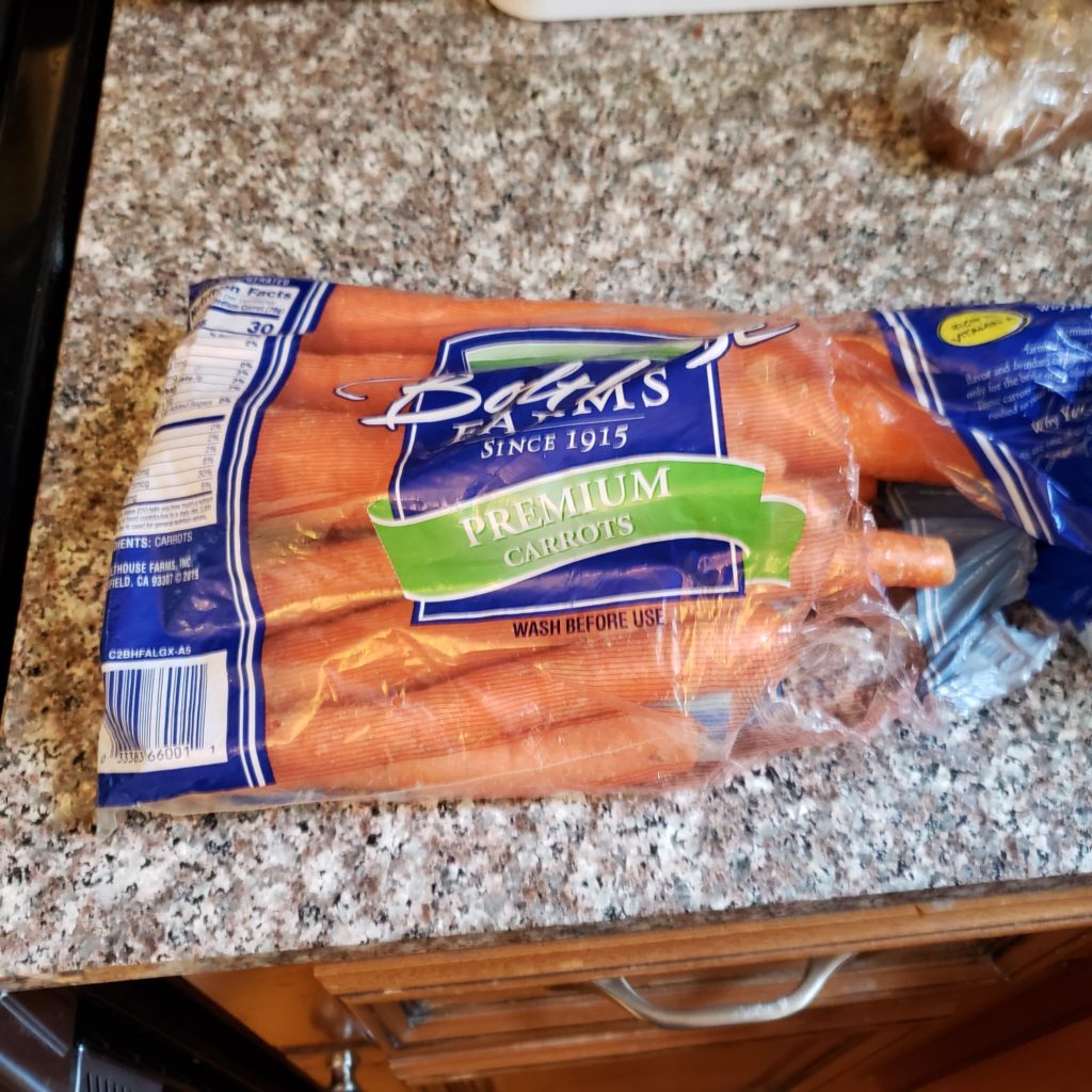 Bag of carrots on a granite countertop