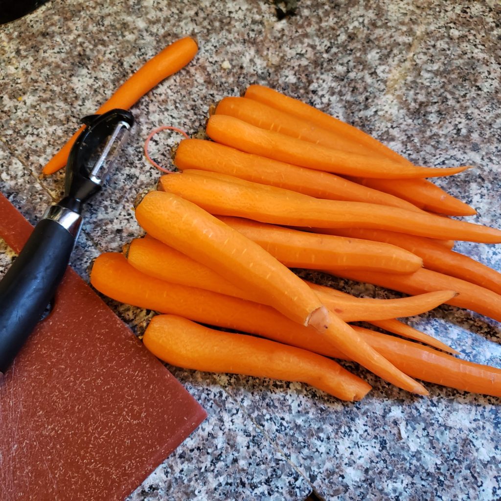 Peeled carrots on a granite countertop