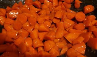 Cider glazed carrots in a black wok
