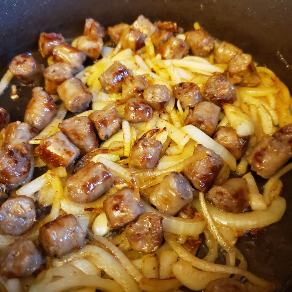 Sausage and onions brwoning in a saute pan for the wouthwest sheepherders breakfast