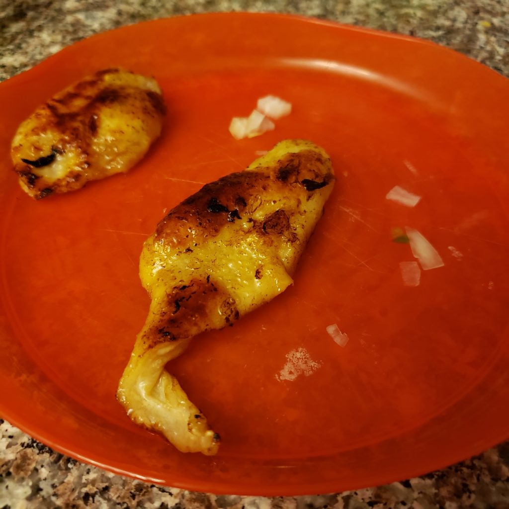 cooked chicken skin on a red plate