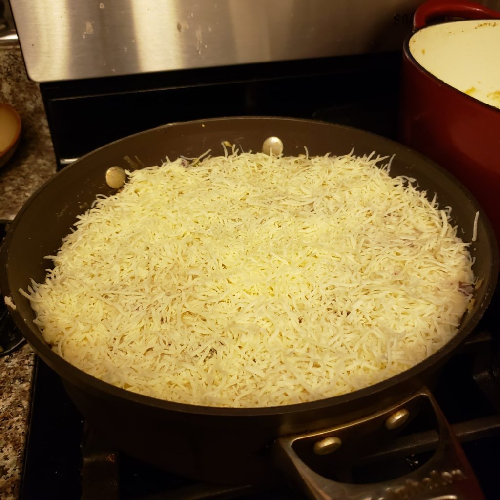 Shepherd's Pie sprinkled with cheese and ready for the oven