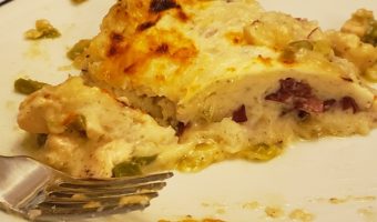 Slice of Chicken Shepherd's Pie on a white plate with a fork