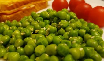 Ramen Peas on a plate with a sandwich and cherry tomatoes
