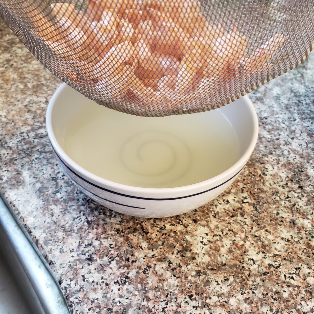 Straining the shells from the shrimp stock