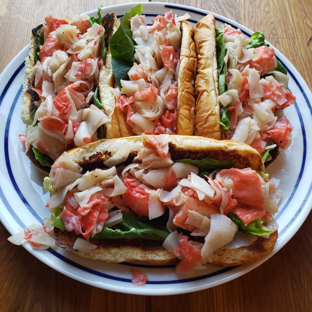4 lobster rolls on a plate