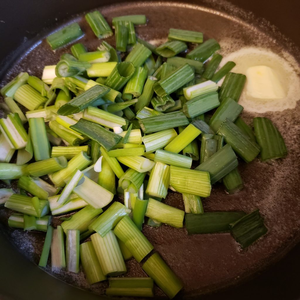 green onions in a saute pan for colcannon