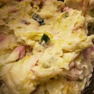 Mashed potatoes with bits of ham, onion, and cooked cabbage