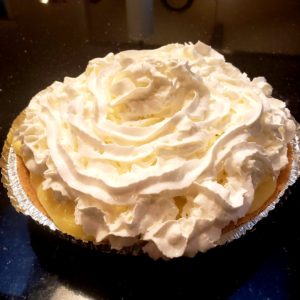 banana cream pie topped with whipped cream