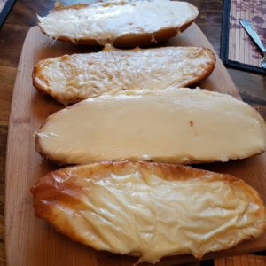 garlic cheese bread on a cutting board