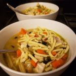 chicken noodle soup in a white soup bowl