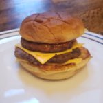 homemade mcdonalds cheeseburger on a white plate