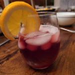 Tinto de Verano in a stemless wine glass with ice and an orange slice